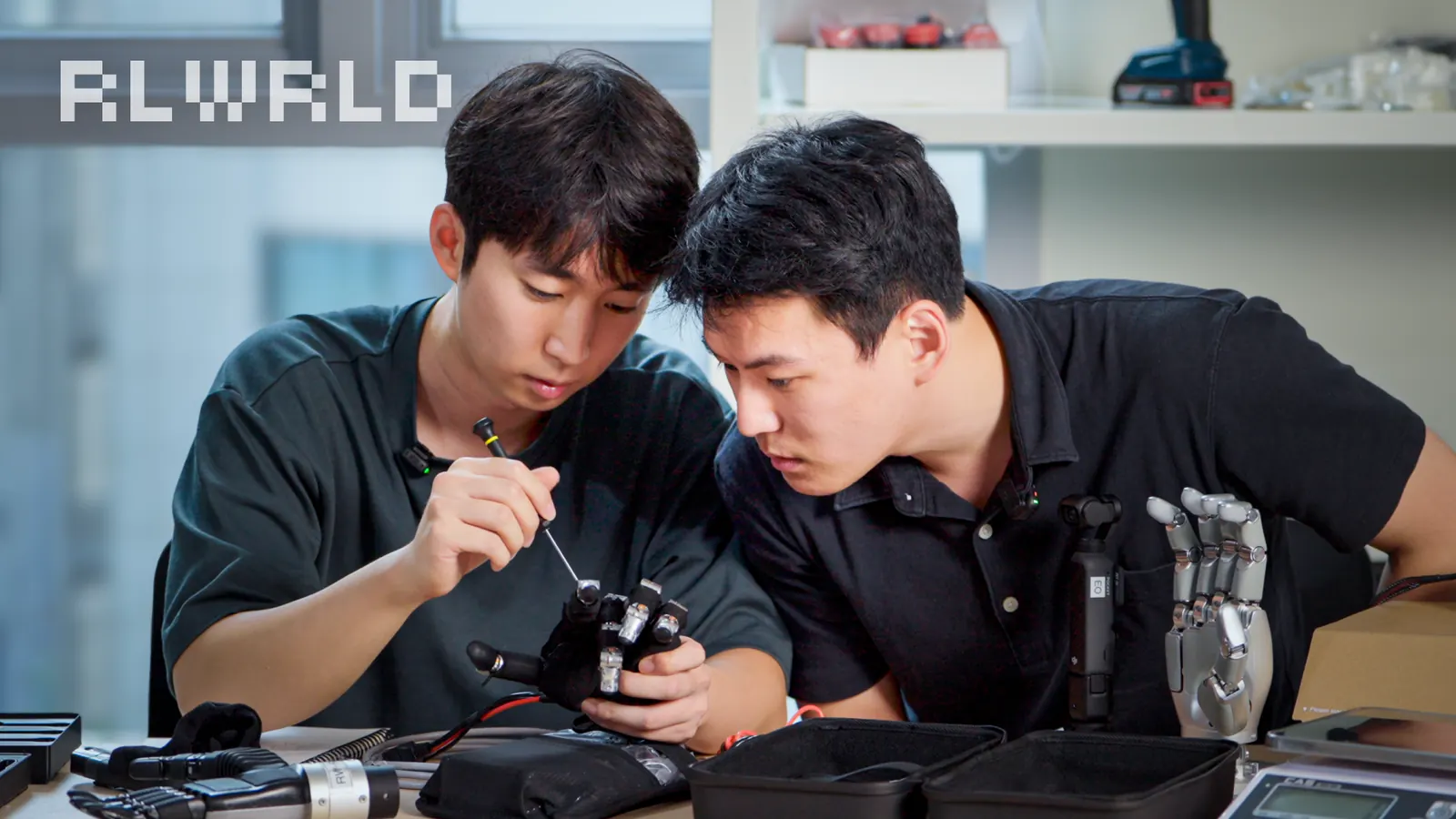 Wuji-2 unboxing IP thumbnail: hosts working on the robot hand