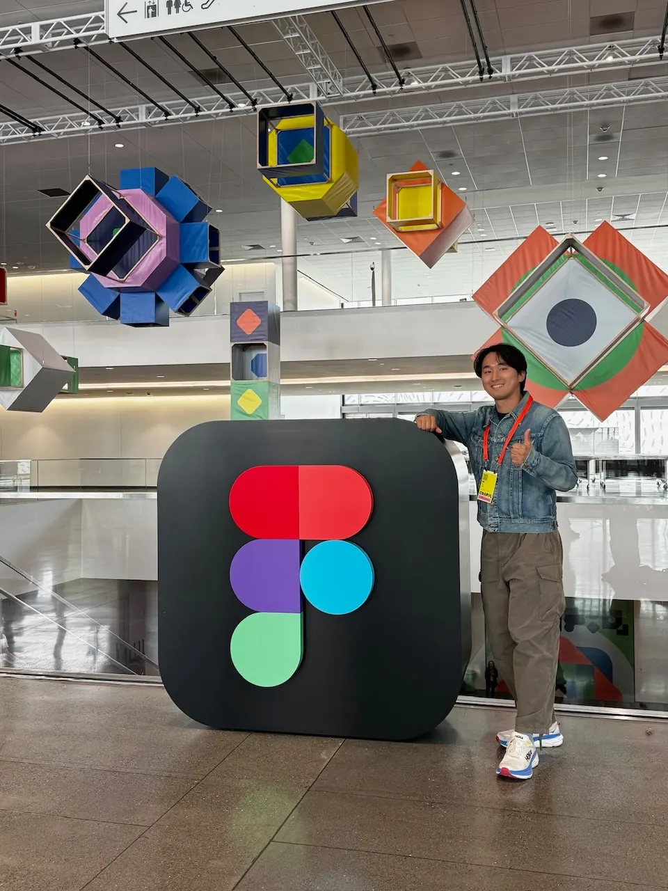 Jemin standing beside a giant Figma logo at Config